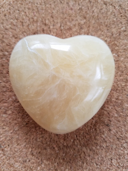 Calcite Heart Stone on cork background