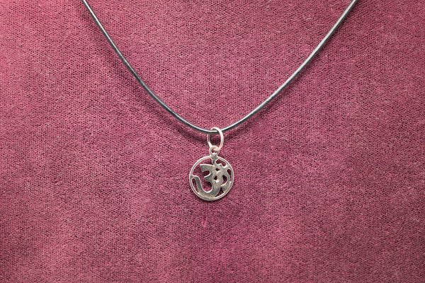 Sterliing Silver OM pendant on maroon background