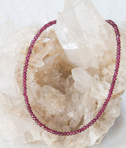 Garnet Necklace draped over Quartz Crystal